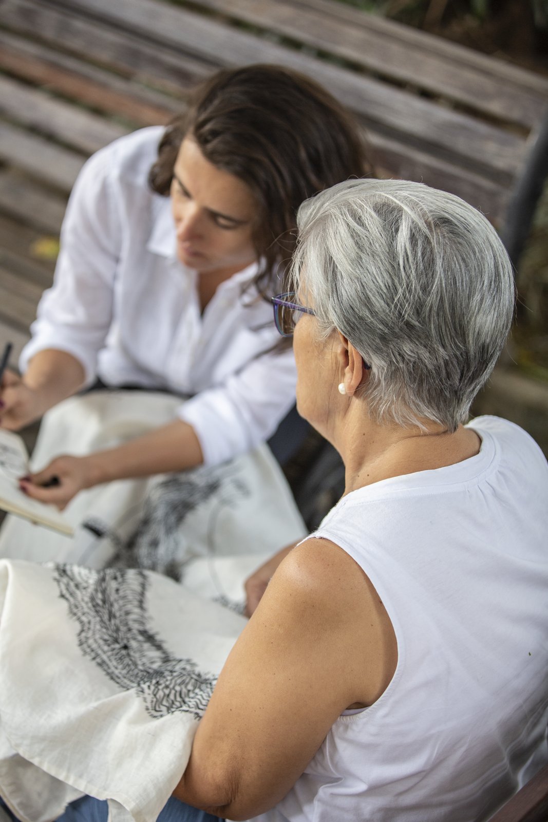 Two women seated together with the linen, in conversation