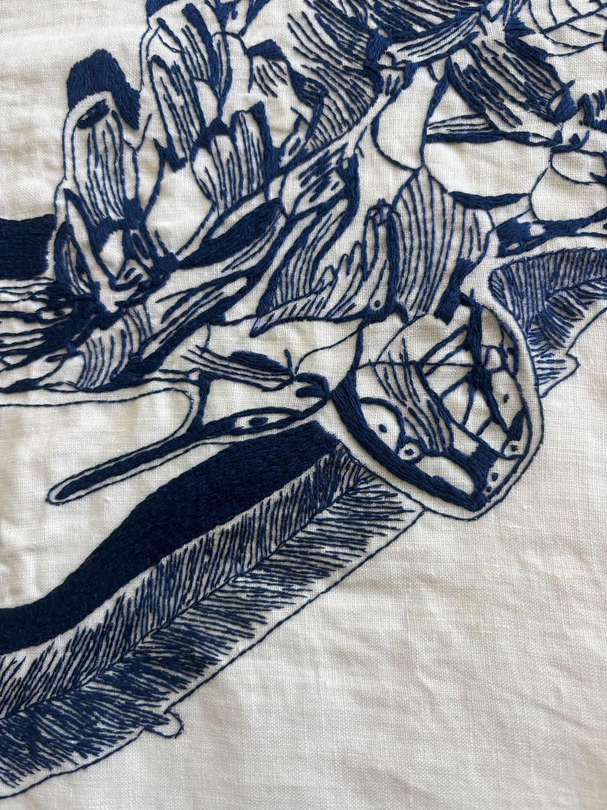 Close detail of navy-thread stitching, feathered texture