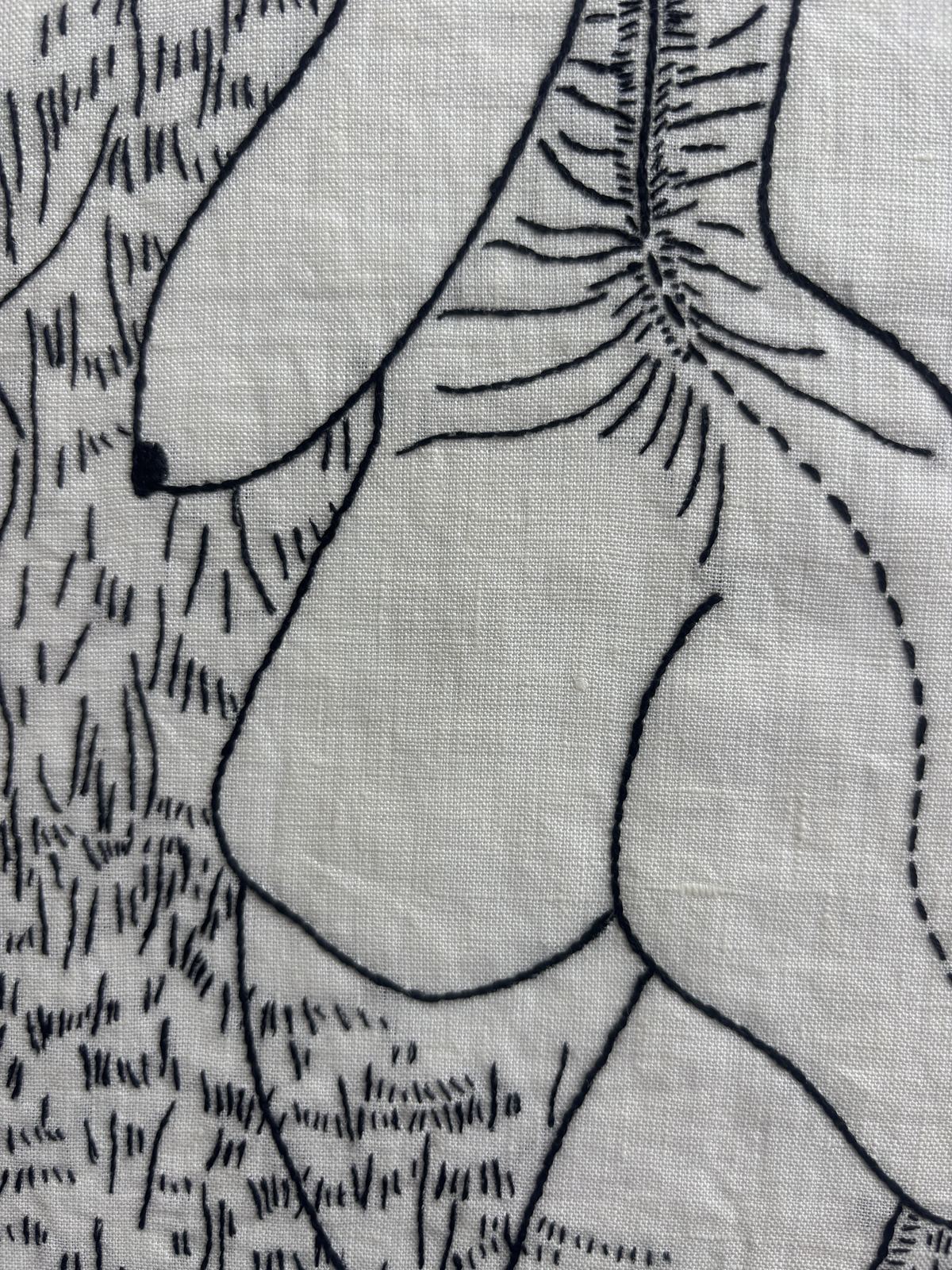 Close detail of black-thread stitching, radiating form