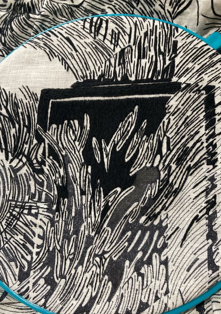 Close detail of black-thread stitching in the hoop